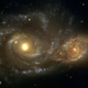Two spiral galaxies passing by each other, but not quite colliding.